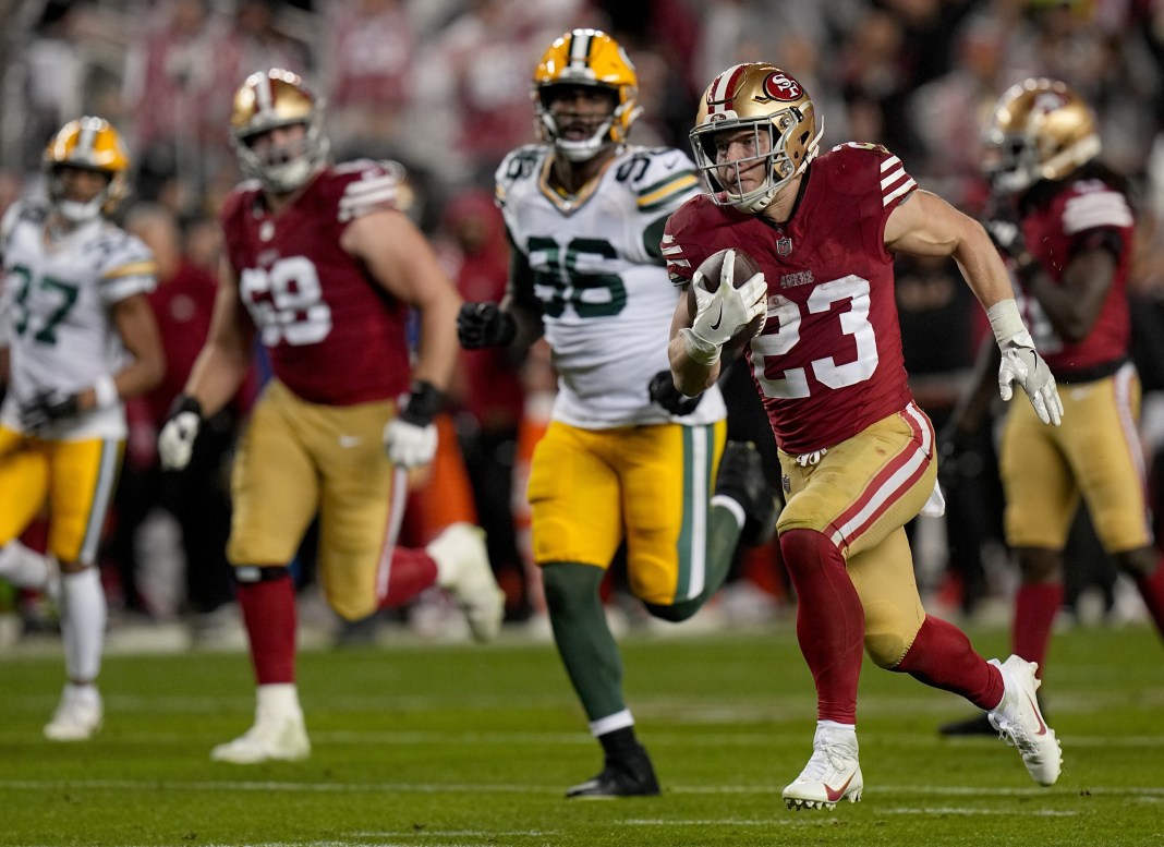 San Francisco 49ers running back Christian McCaffrey scores a touchdown during a game against the Green Bay Packers.