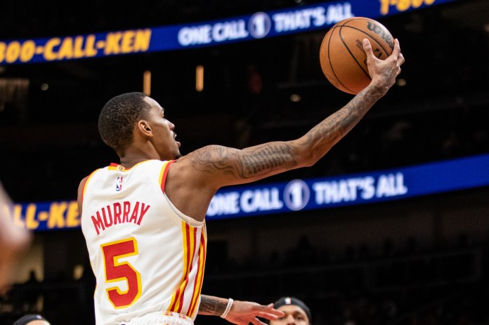 Atlanta Hawks guard Dejounte Murray lays in the ball against Orlando Magic during fourth quarter at State Farm Arena.