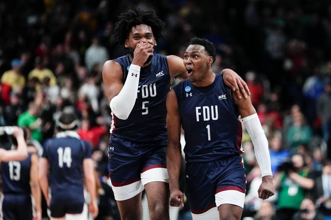 Fairleigh Dickinson Knights guard Joe Munden Jr. and forward Ansley Almonor celebrate their win over the Purdue Boilermakers.