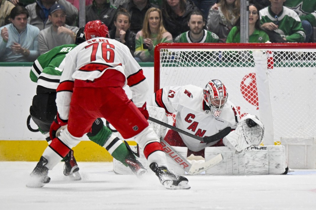 Carolina Hurricanes goaltender Pyotr Kochetkov (52) makes a glove save on a shot by Dallas Stars center Ty Dellandrea (10