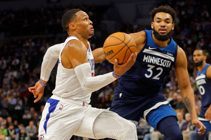 Los Angeles Clippers guard Russell Westbrook (0) drives to the basket past Minnesota Timberwolves forward Karl-Anthony Towns (32)