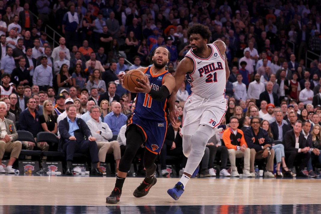 Knicks guard Jalen Brunson drives to the basket against 76ers center Joel Embiid in game 5 of the 2024 NBA playoffs.