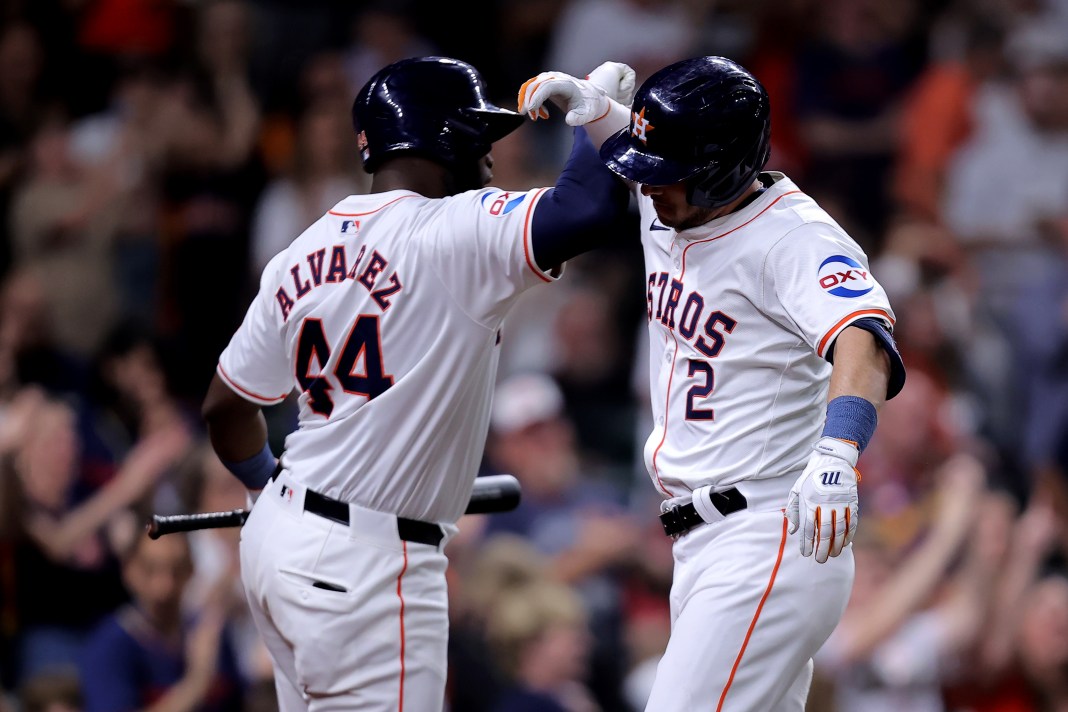 Houston Astros third baseman Alex Bregman celebrates with Houston Astros designated hitter Yordan Alvarez after hitting a home run.