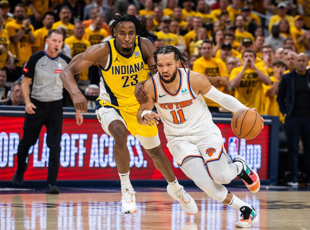 New York Knicks guard Jalen Brunson (11) dribbles the ball while Indiana Pacers forward Aaron Nesmith (23) defends