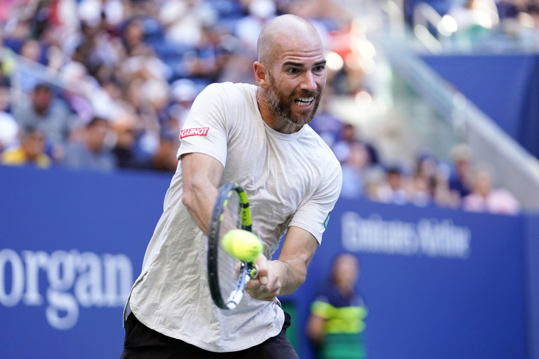 Adrian Mannarino hits a backhand in his match against Frances Tiafoe at the 2023 US Open.