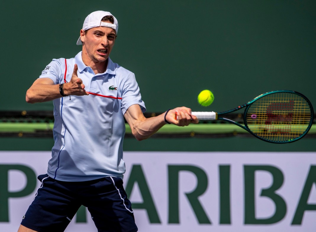 Ugo Humbert hits a forehand during a doubles match at Indian Wells.