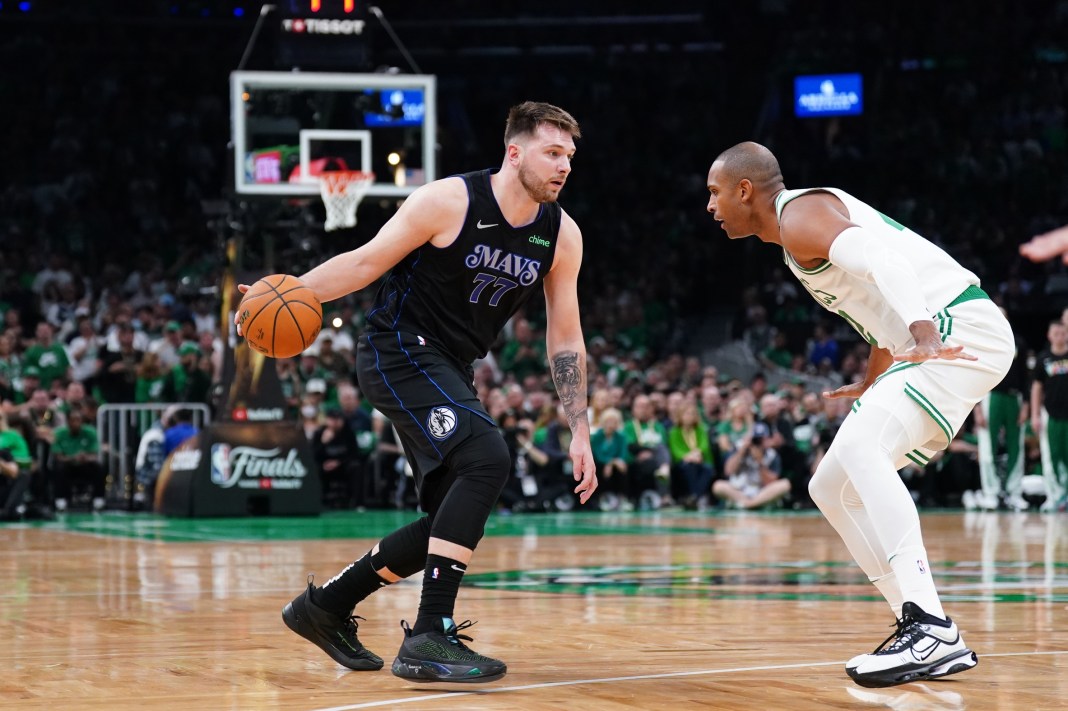 Dallas Mavericks star Luka Doncic looks to drive on Boston Celtics big man Al Horford in Game 1 of the NBA Finals.