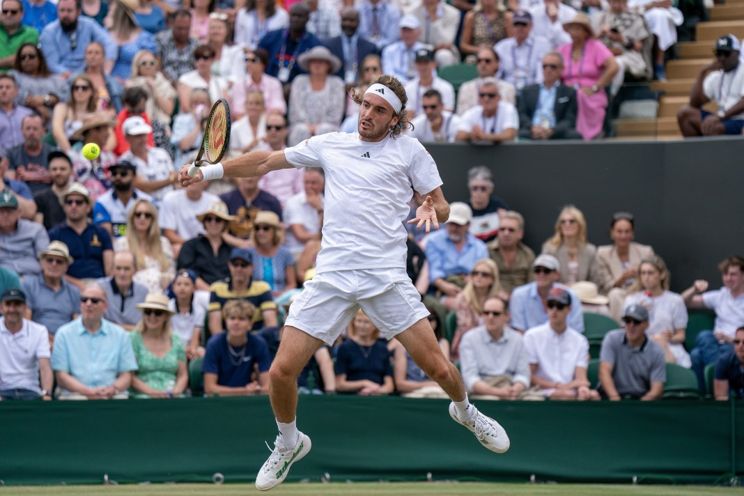 Stefanos Tsitsipas hits a backhand in his loss to Christopher Eubanks at Wimbledon in 2023.