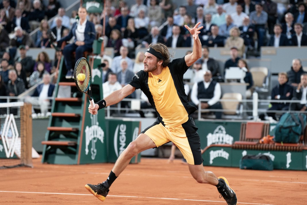 Stefanos Tsitsipas hits a volley in his match against Carlos Alcaraz at the French Open.