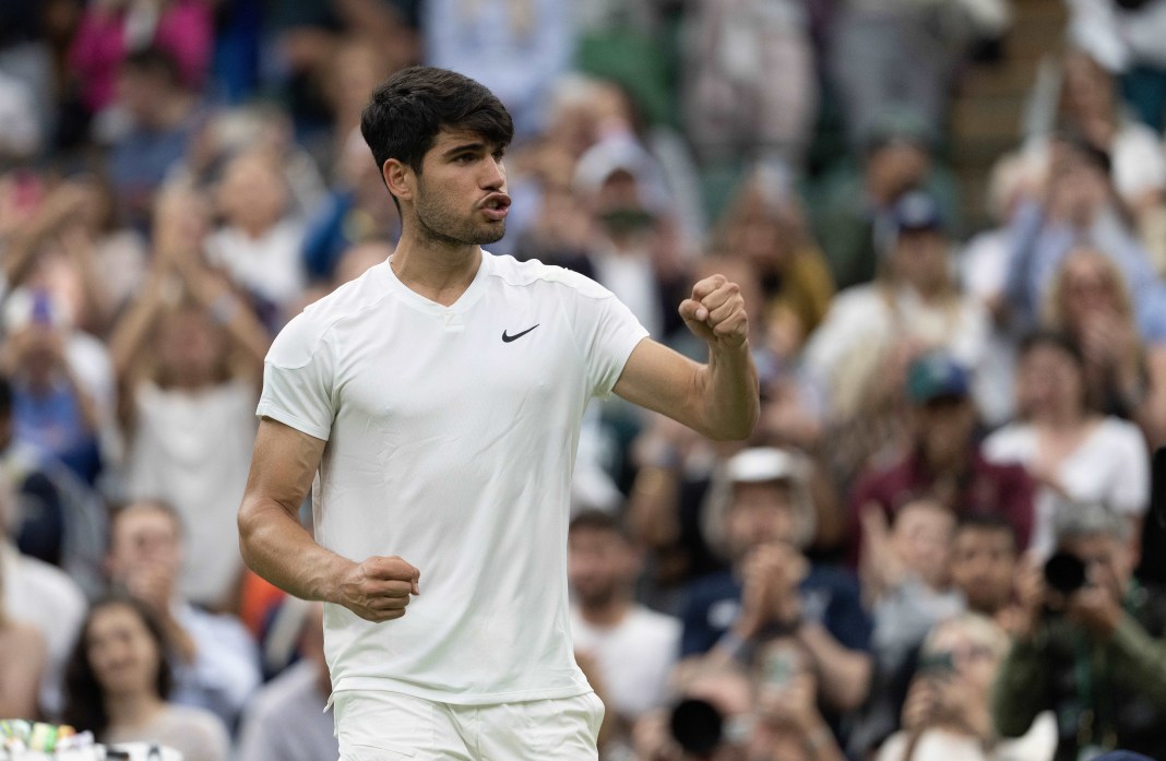 Carlos Alcaraz celebrates a big win over Tommy Paul in the Wimbledon quarterfinals.