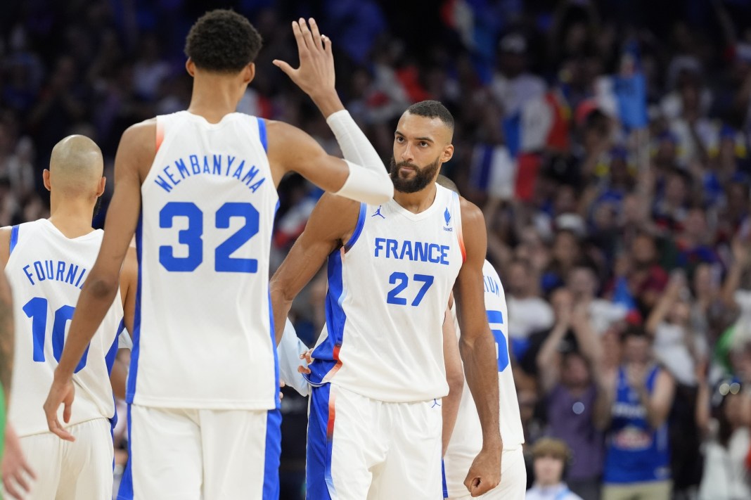 Victor Wembanyama and Rudy Gobert celebrate France's win over Brazil at the 2024 Paris Olympics.