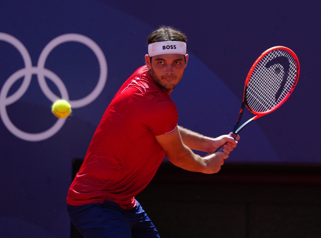 Taylor Fritz hits a backhand at the 2024 Paris Olympics.