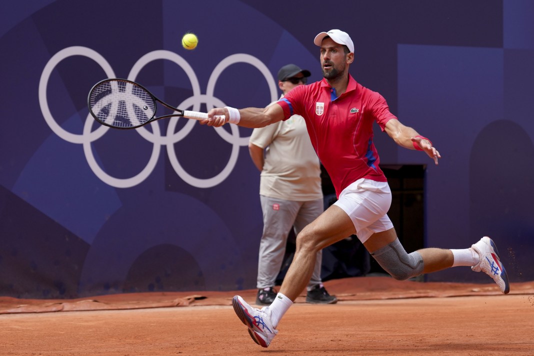 Novak Djokovic hits a forehand in his match against Rafael Nadal at the Paris Olympics.