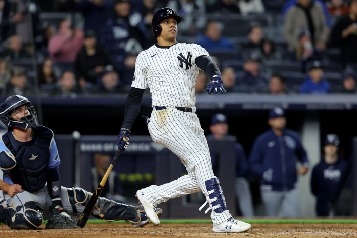 New York Yankees right fielder Juan Soto (22) follows through on a three-run home run during the seventh inning against the Tampa Bay Rays at Yankee Stadium in the Bronx, New York, on April 19, 2024.
