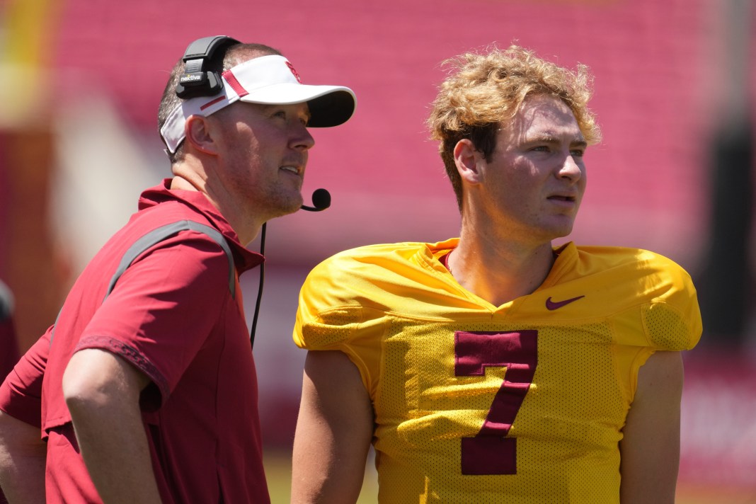 USC head coach Lincoln Riley talks to quarterback Miller Moss in practice.