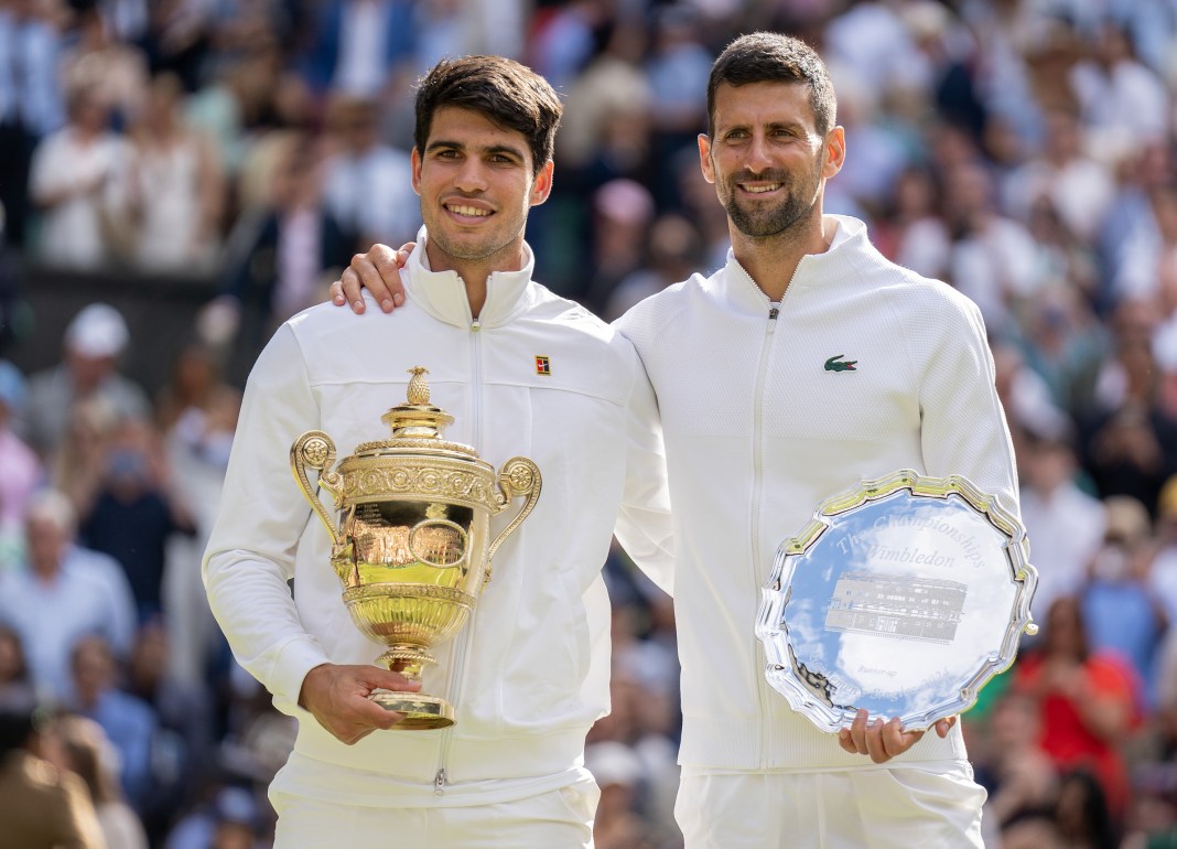 Carlos Alcaraz and Novak Djokovic pose for a picture after the Wimbledon final in 2024.