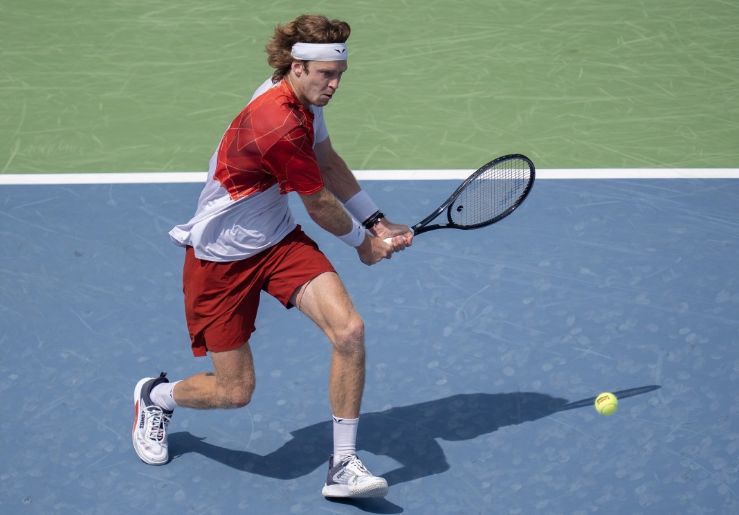 Andrey Rublev hits a backhand in his match against Jannik Sinner at the Cincinnati Open.