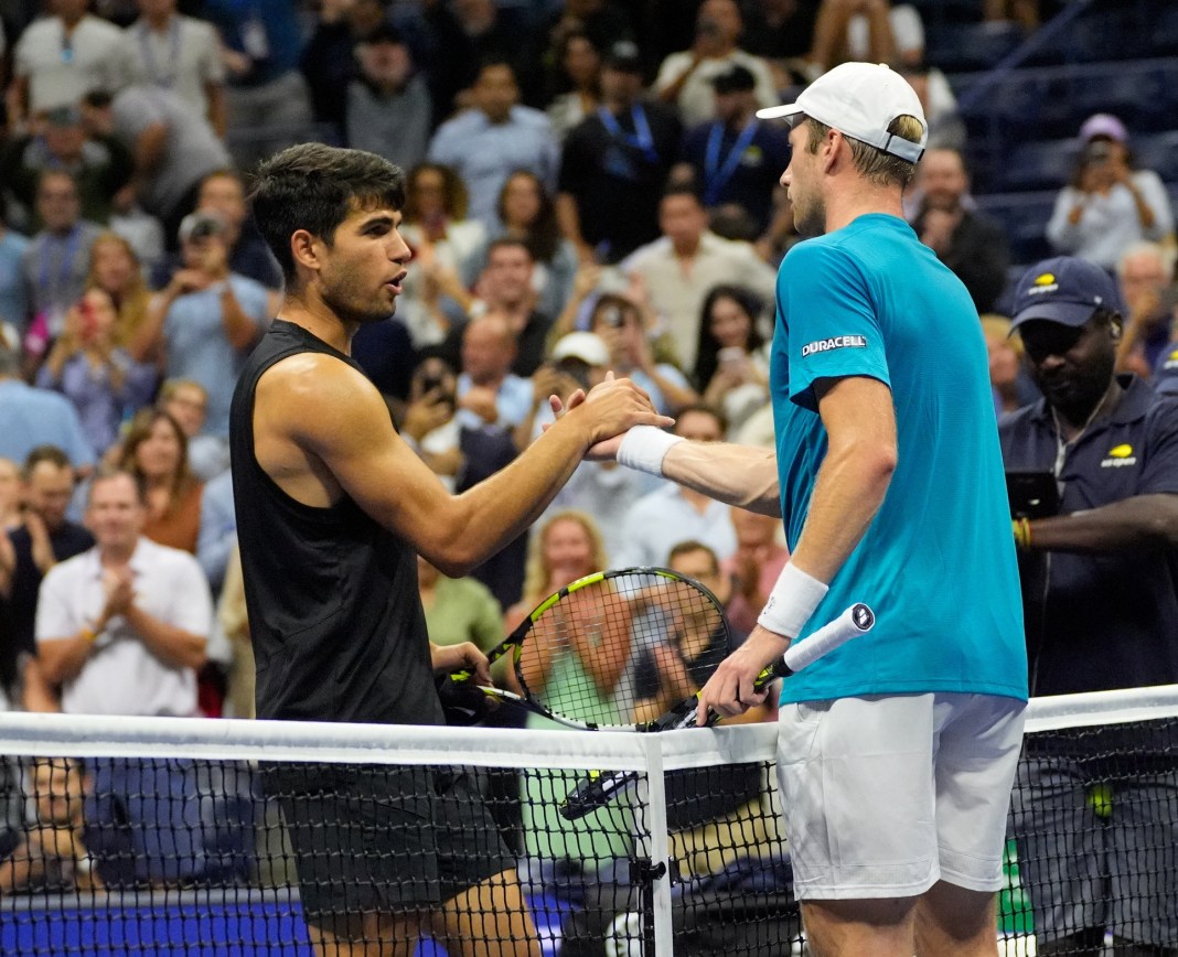 Carlos Alcaraz greets Botic van de Zandschulp at the net after his upset loss at the 2024 US Open.