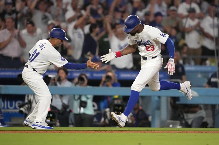 Los Angeles Dodgers right fielder Jason Heyward (23) celebrates with third base coach Dino Ebel (91) after hitting a three-run home run in the eighth inning of the game against the Seattle Mariners at Dodger Stadium in Los Angeles, California, on August 20, 2024.