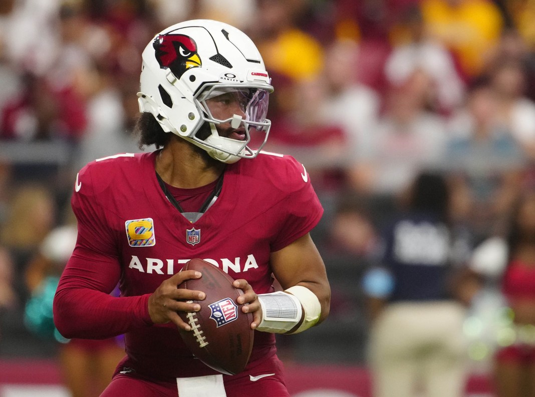 Cardinals quarterback Kyler Murray looks to make a play against the Commanders.