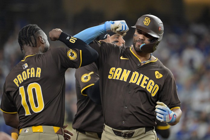 San Diego Padres second baseman Xander Bogaerts (2) celebrates with outfielder Jurickson Profar (10) after hitting a solo home run in the eighth inning against the Los Angeles Dodgers during Game 2 of the NLDS for the 2024 MLB Playoffs at Dodger Stadium on October 6, 2024.