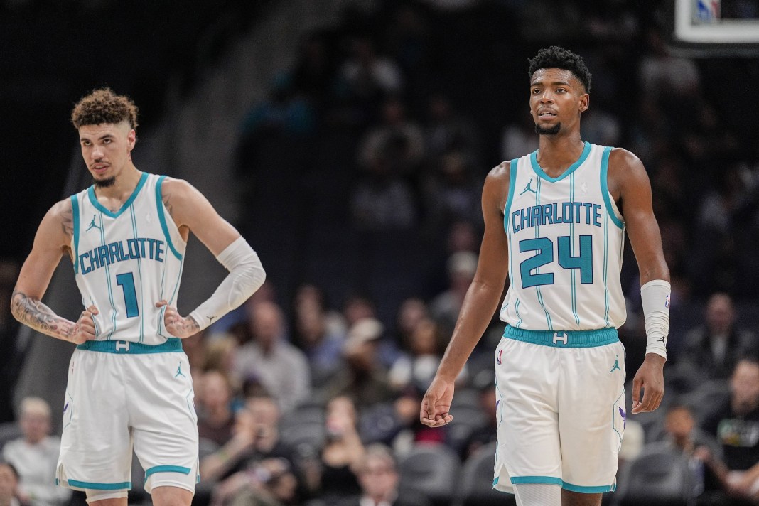 Hornets stars LaMelo Ball and Brandon Miller walk during a preseason game.