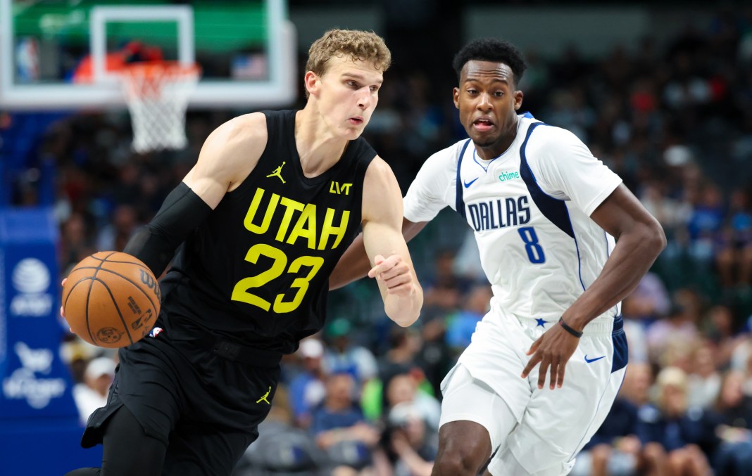 Jazz star Lauri Markkanen drives to the basket in a preseason game.