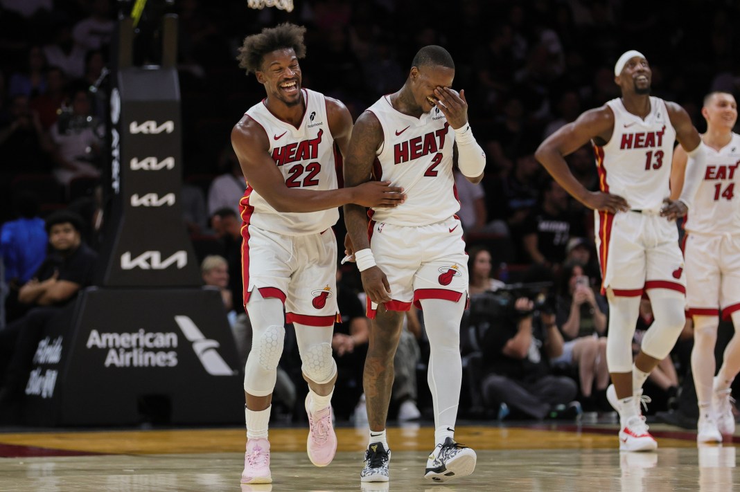 Heat star Jimmy Butler clowns around with his teammates in a preseason game against the Spurs.