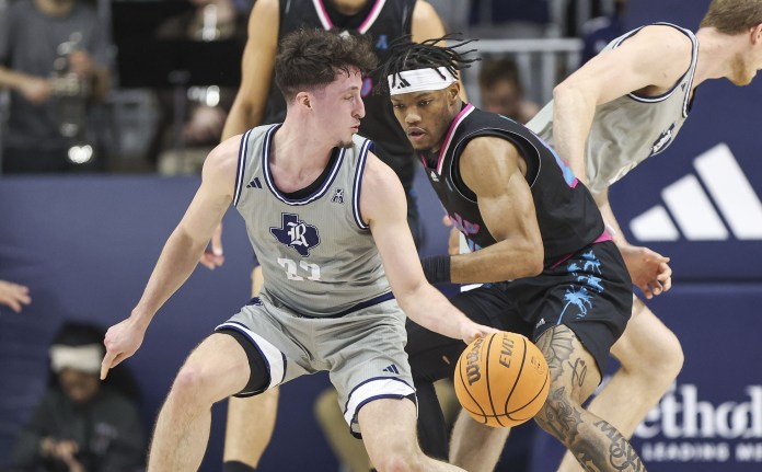 Rice Owls guard Alem Huseinovic (23) attempts to control the ball as Florida Atlantic Owls guard Alijah Martin (15) defends
