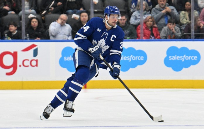 Toronto Maple Leafs forward Auston Matthews (34) skates with the puck against the Seattle Kraken in the first period at Scotiabank Arena.