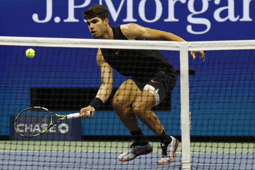 Carlos Alcaraz hits a volley in a match against Botic van de Zandschulp at the 2024 US Open.