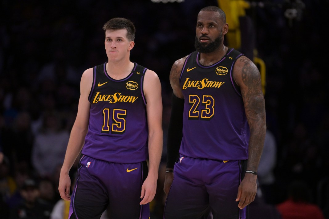 Lakers star LeBron James and guard Austin Reaves look on in a meeting with the Magic in the 2024-25 NBA season.