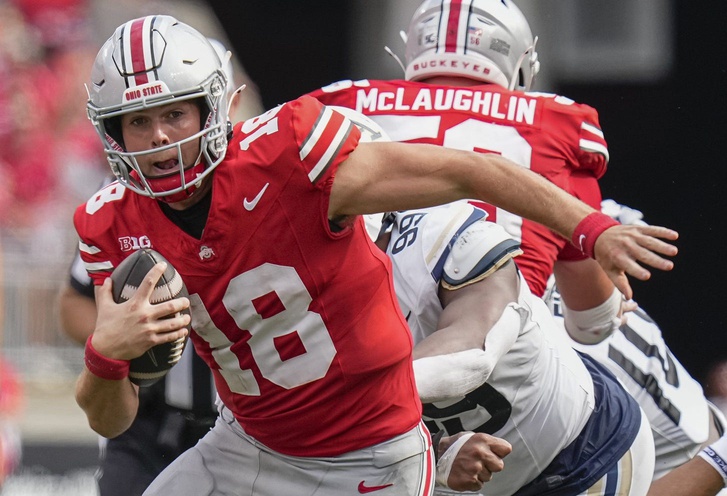 Ohio State Buckeyes quarterback Will Howard scrambles out of the pocket during the NCAA football game against the Akron Zips.