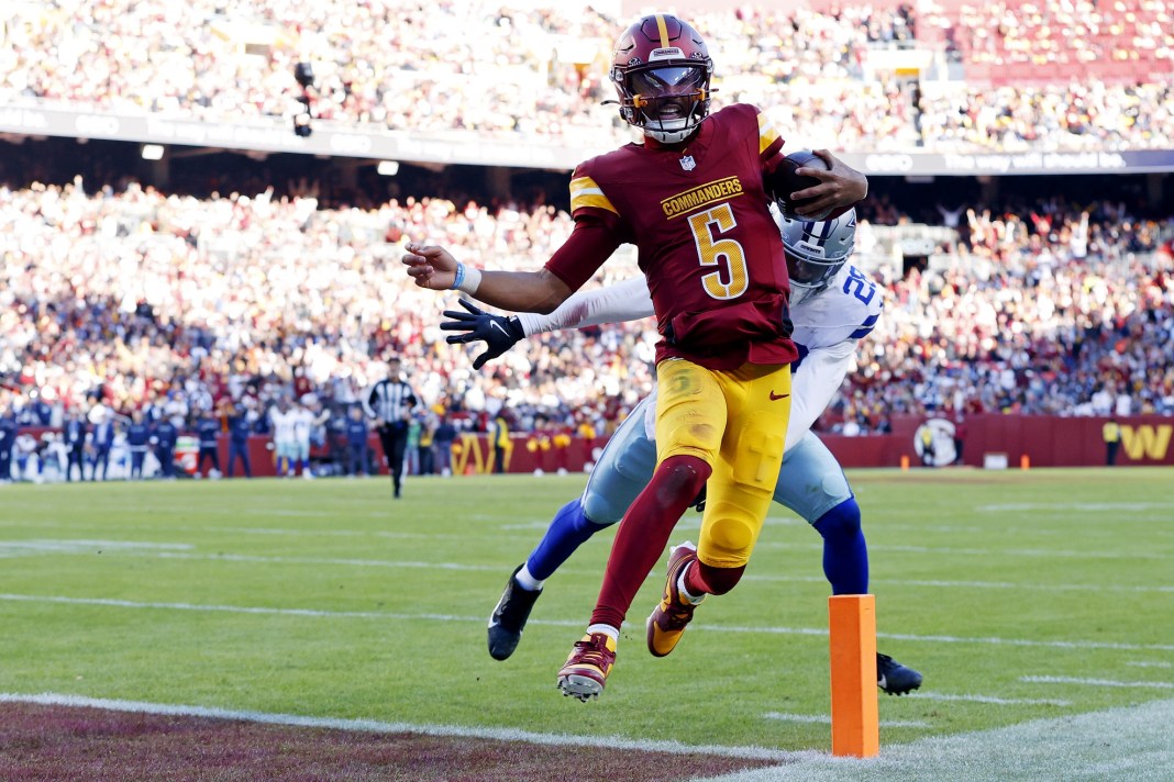 Washington Commanders quarterback Jayden Daniels runs for a touchdown against Dallas Cowboys safety Malik Hooker