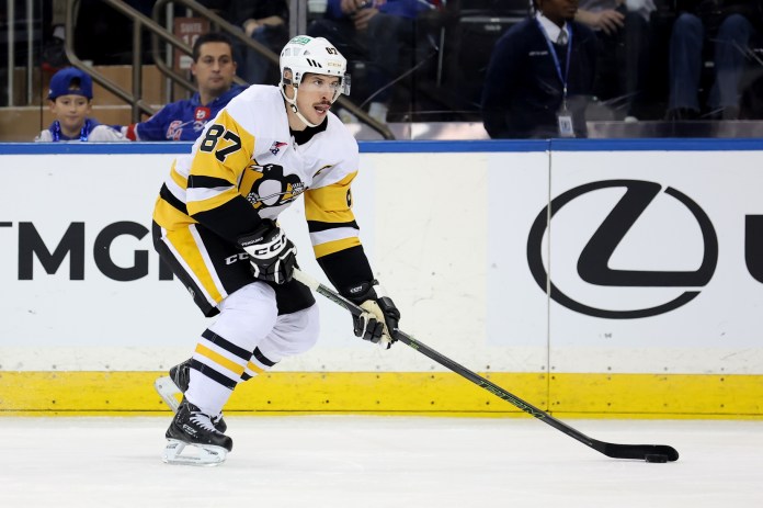 ittsburgh Penguins center Sidney Crosby skates with the puck against the New York Rangers