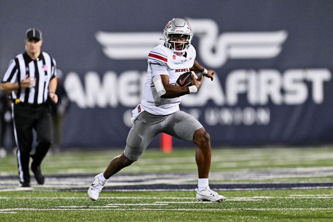 UNLV Rebels quarterback Hajj-Malik Williams (6) runs with the ball against the Utah State Aggies