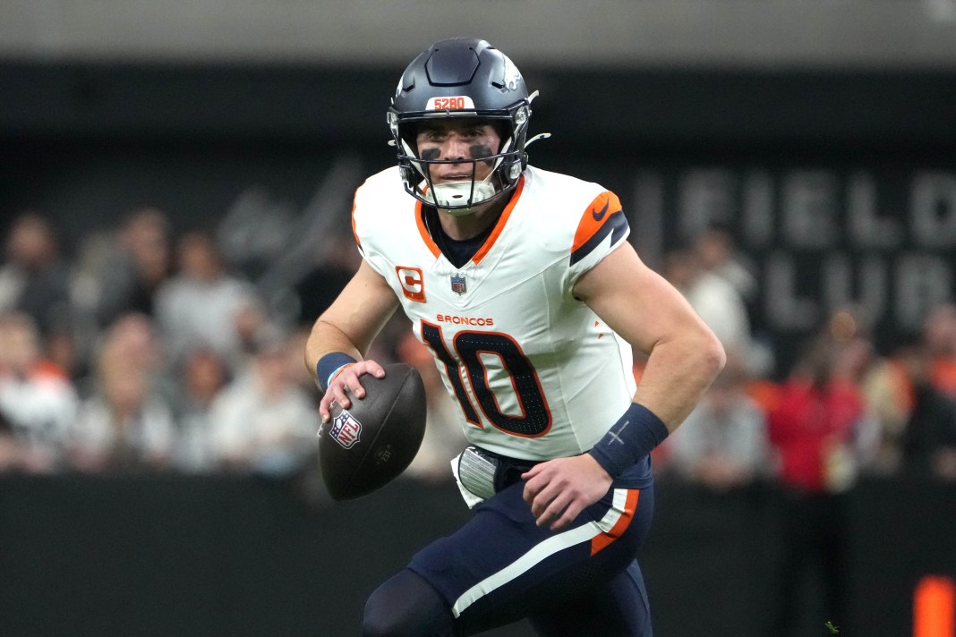 Broncos quarterback Bo Nix looks to make a play in a meeting with the Raiders during the 2024 NFL season.