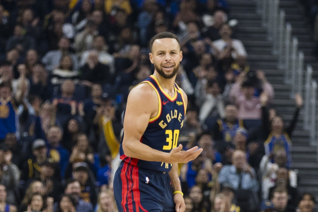 Warriors superstar Stephen Curry celebrates a made 3 against the Nets during the 2024-25 NBA season.