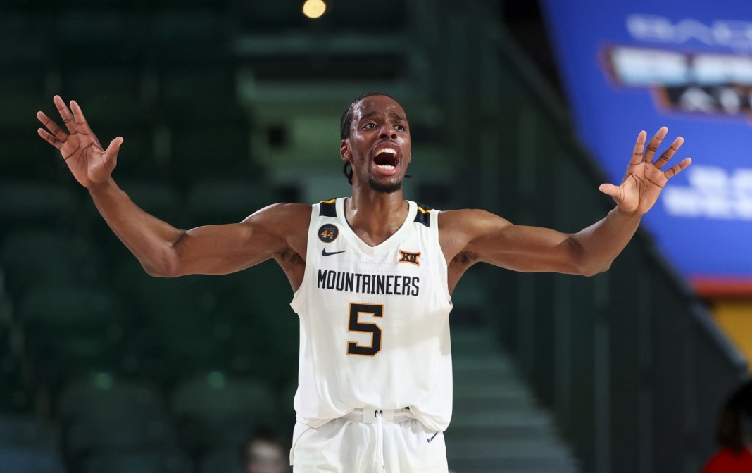 West Virginia Mountaineers guard Toby Okani (5) reacts against the Arizona Wildcats during overtime at Imperial Aren