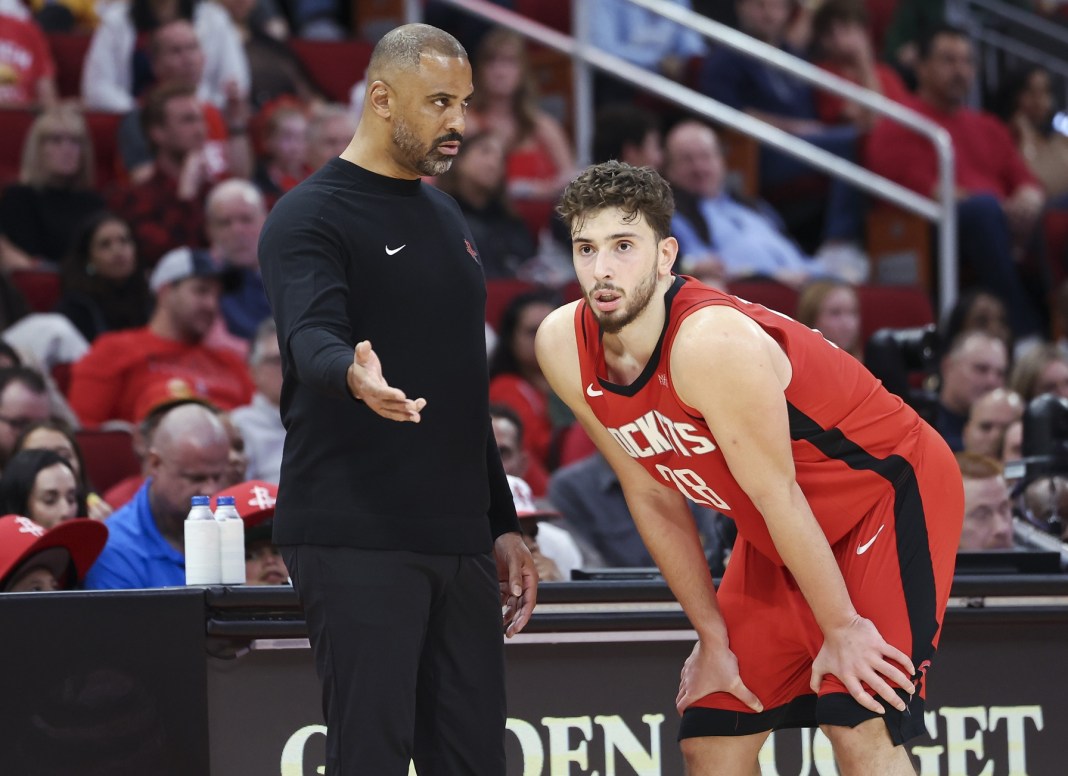 Rockets head coach Ime Udoka talks to Alperen Sengun during a meeting with the Thunder in the 2024-25 NBA season.