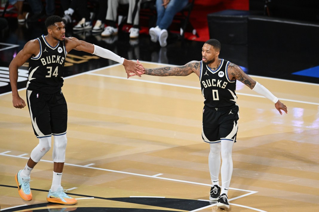 Bucks stars Giannis Antetokounmpo and Damian Lillard react to a play against the Hawks in the Emirates NBA Cup during the 2024-25 season.