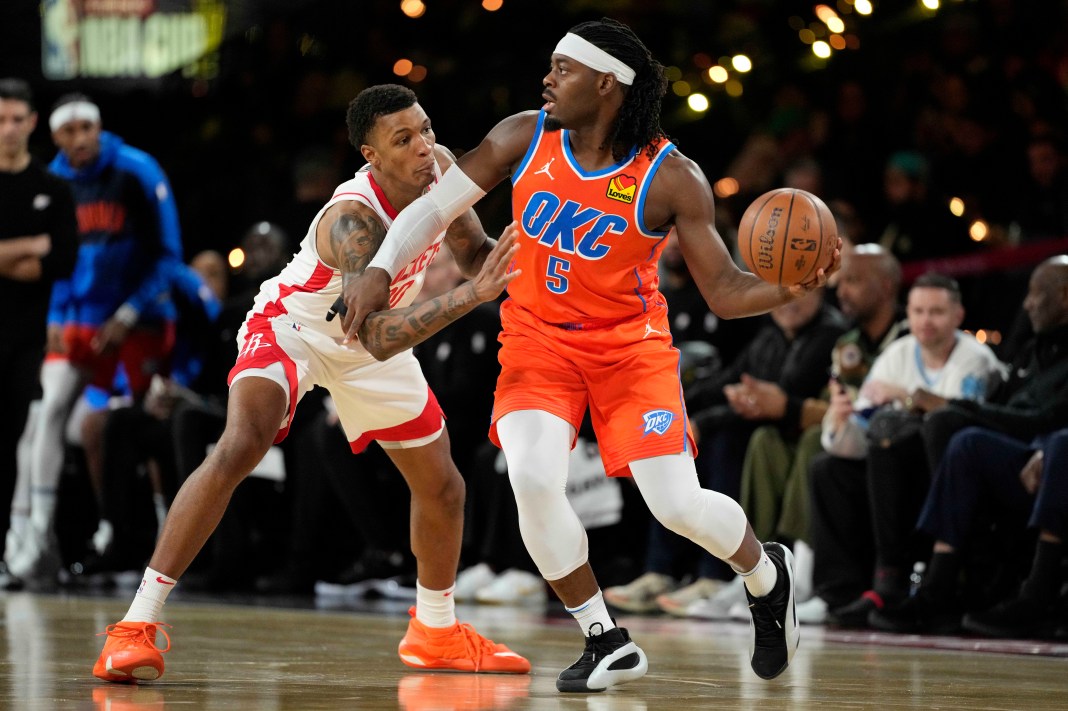 Oklahoma City Thunder guard Luguentz Dort controls the ball against Houston Rockets forward Jabari Smith Jr.