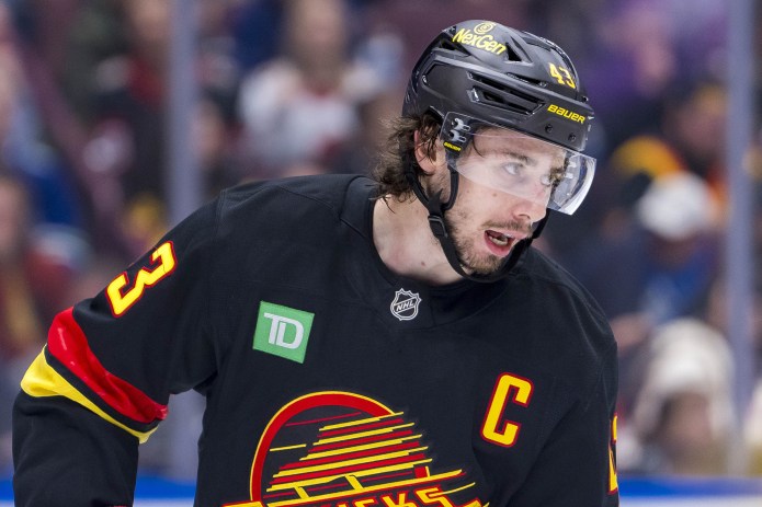 Vancouver Canucks defenseman Quinn Hughes (43) pauses during a stoppage in play against the Ottawa Senators in the third period at Rogers Arena on December 21, 2024