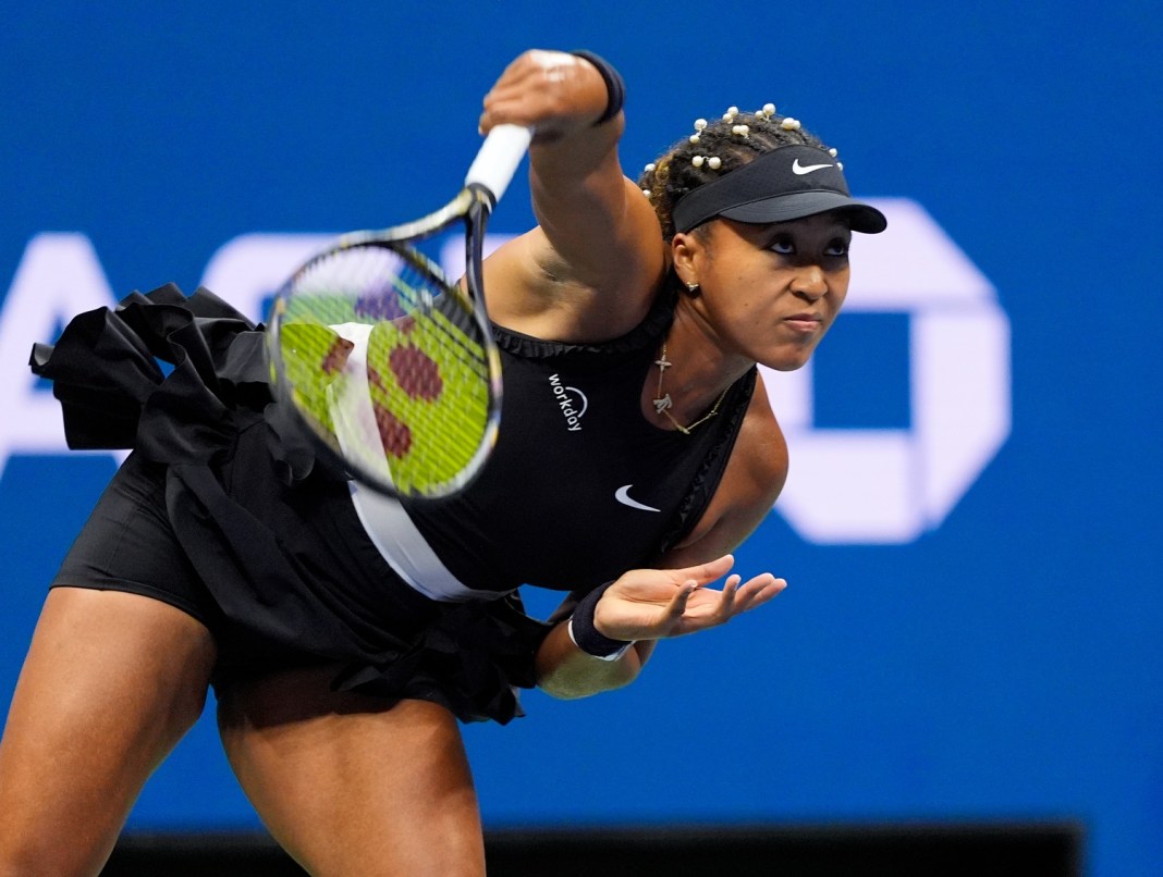 Naomi Osaka hits a serve at the 2024 US Open.