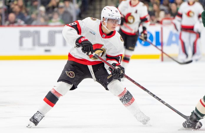 Ottawa Senators center Tim Stutzle (18) carries the puck over the blue line during the third period against the Minnesota Wild at Xcel Energy Center on December 29, 2024.