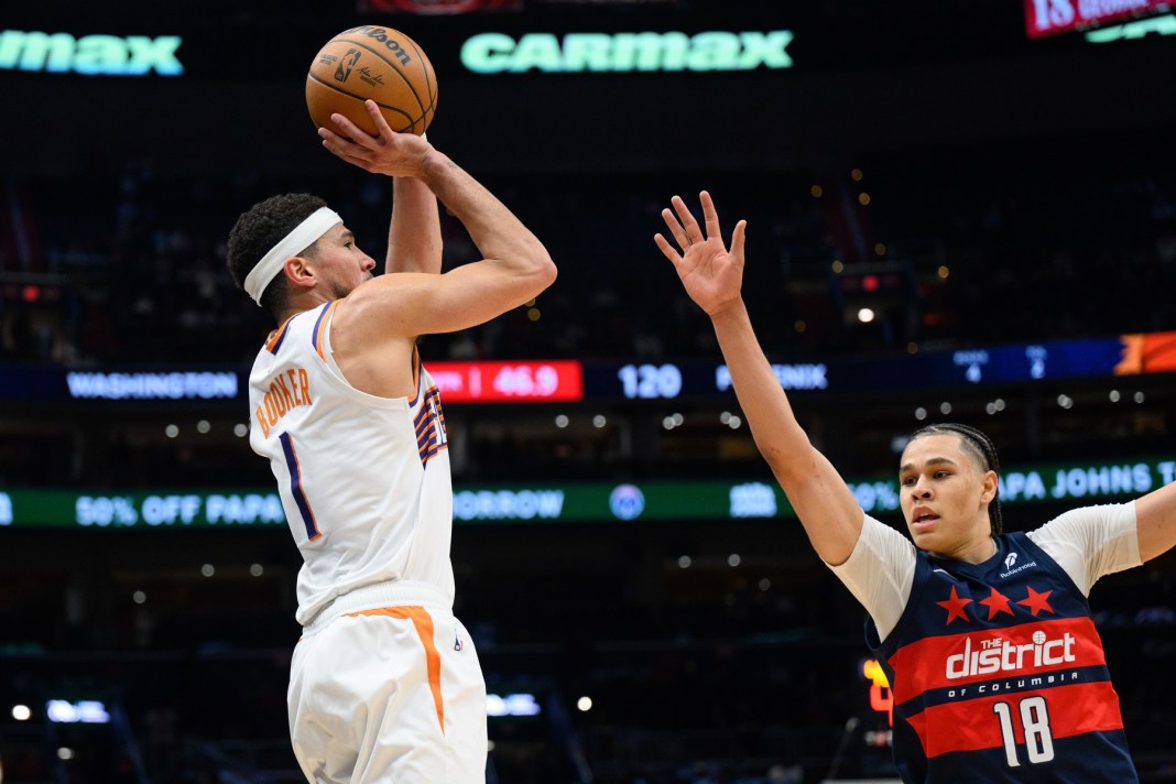 Suns star Devin Booker takes a jumper against the Wizards during the 2024-25 NBA season.