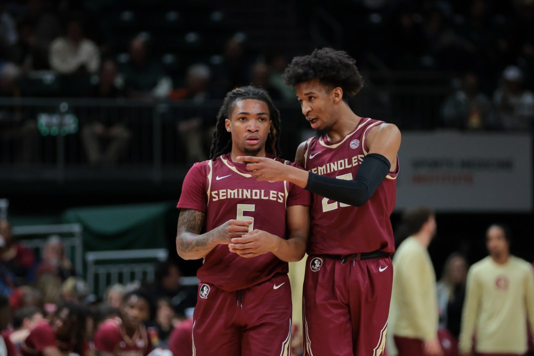 Florida State Seminoles guard Justin Thomas (25) talks with guard Daquan Davis (5) during the first half against the Miami Hurricanes at Watsco Center on January 8, 2025.