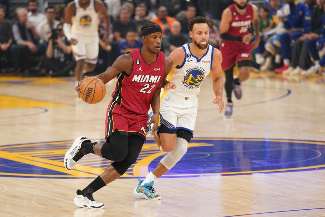 Warriors superstar Stephen Curry trails new teammate Jimmy Butler in a game in 2022.