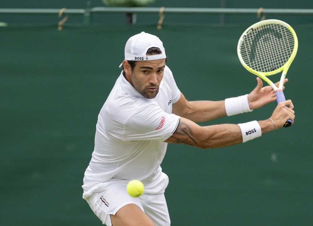 Matteo Berrettini looks to hit a backhand at Wimbledon in 2024.