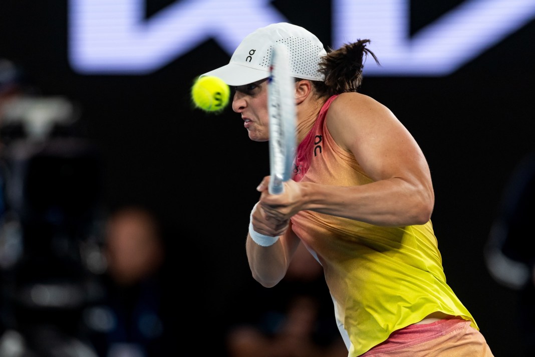 Iga Swiatek hits a backhand against Madison Keys at the 2025 Australian Open.